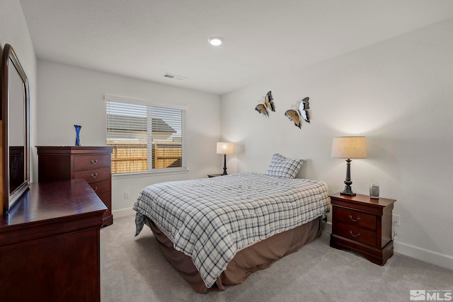 bedroom featuring light colored carpet