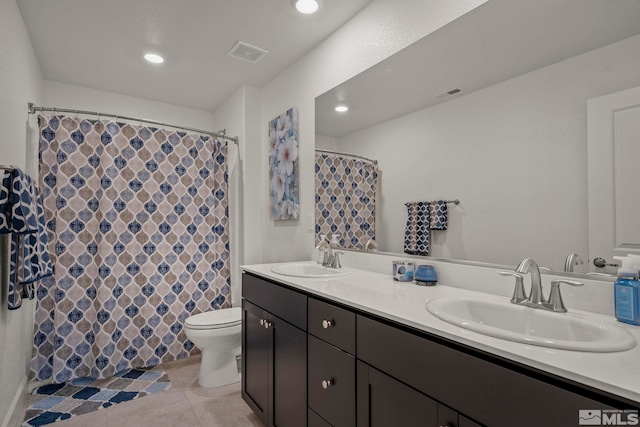 bathroom featuring tile patterned flooring, vanity, and toilet