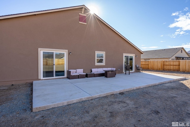 rear view of house featuring a patio and outdoor lounge area