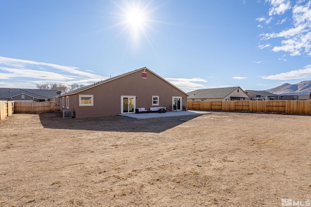 rear view of property featuring central AC and a patio area