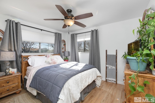 bedroom with ceiling fan and light hardwood / wood-style floors