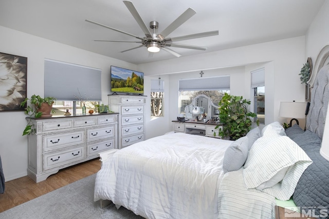 bedroom with hardwood / wood-style flooring and ceiling fan