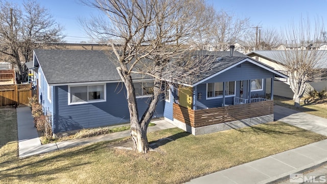 bungalow with a front yard and covered porch