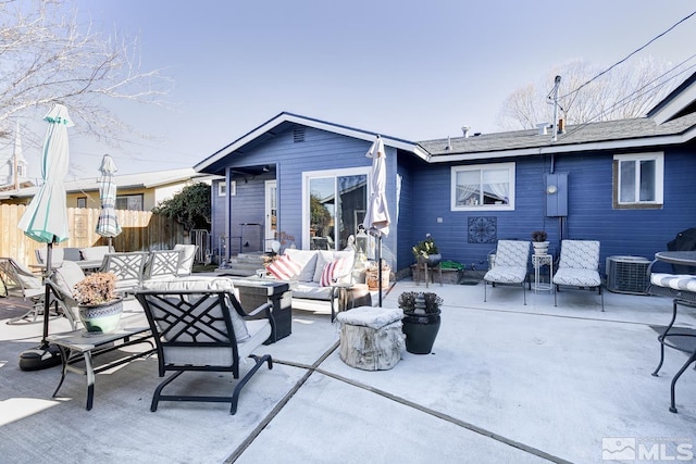 back of property with an outdoor living space, central AC unit, and a patio