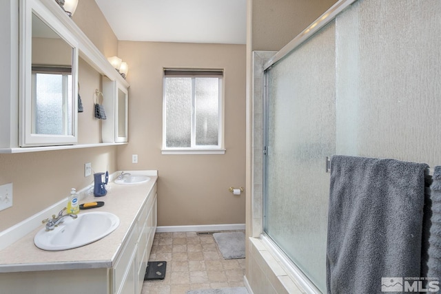 bathroom featuring vanity, plenty of natural light, and walk in shower