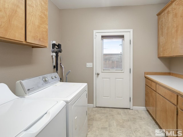 washroom featuring cabinets and washer and dryer