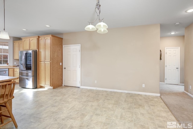 kitchen featuring pendant lighting, light carpet, stainless steel appliances, and light brown cabinets