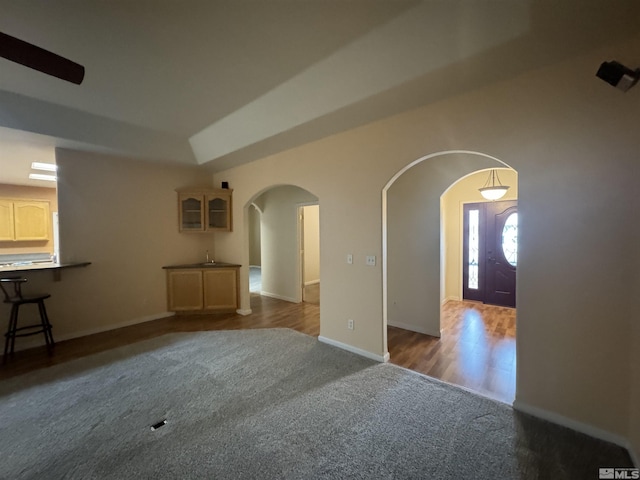 unfurnished living room featuring dark carpet