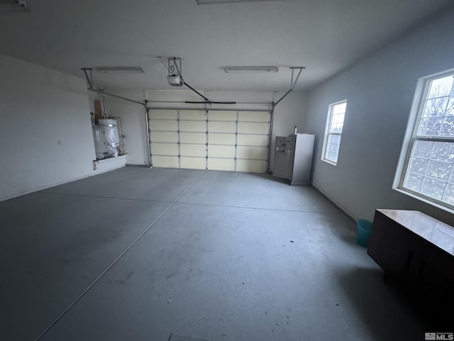 garage featuring a garage door opener and water heater