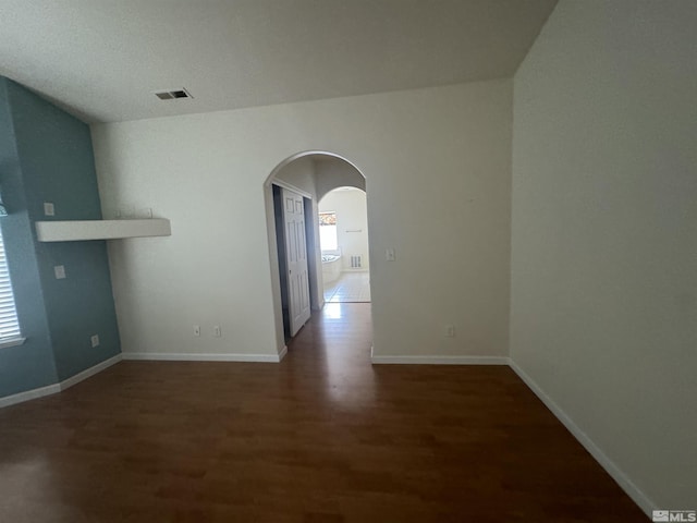 unfurnished room with dark hardwood / wood-style flooring