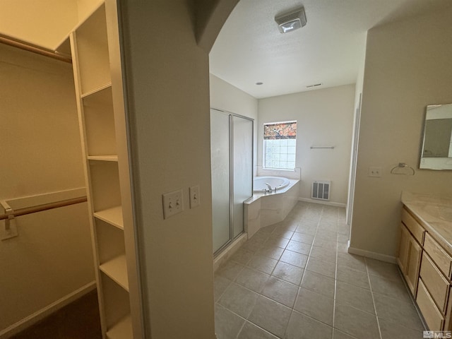 bathroom featuring vanity, shower with separate bathtub, and tile patterned floors