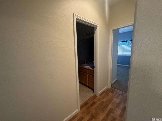 corridor with sink and light hardwood / wood-style floors