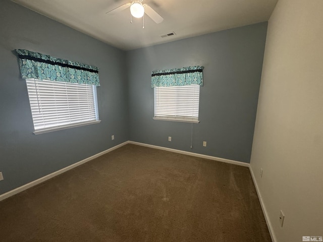 carpeted spare room featuring ceiling fan