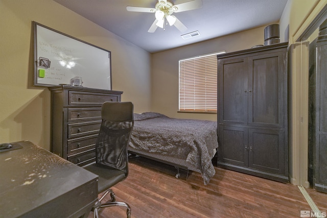 bedroom featuring dark hardwood / wood-style flooring and ceiling fan