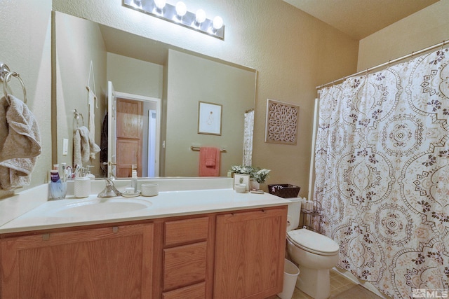 bathroom with vanity, toilet, and tile patterned flooring