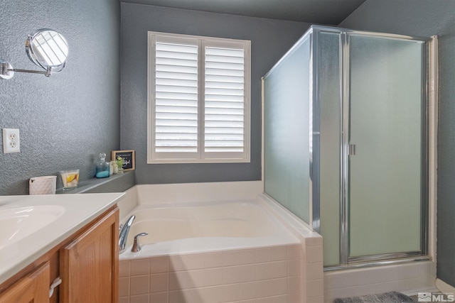 bathroom with plenty of natural light, shower with separate bathtub, and vanity