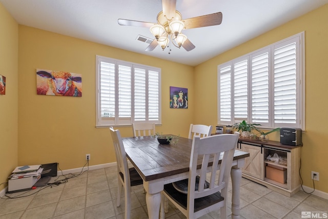 tiled dining space with ceiling fan