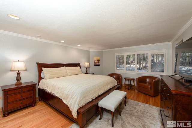 bedroom featuring ornamental molding and light hardwood / wood-style flooring