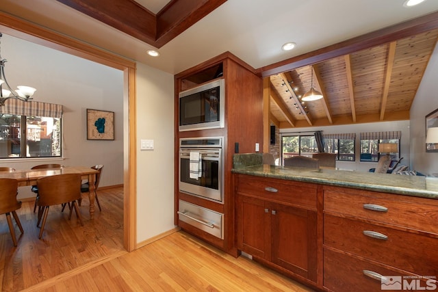 kitchen with built in microwave, vaulted ceiling with beams, wood ceiling, stainless steel oven, and light hardwood / wood-style floors