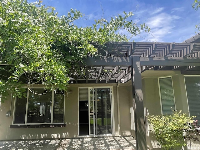 back of house with a pergola