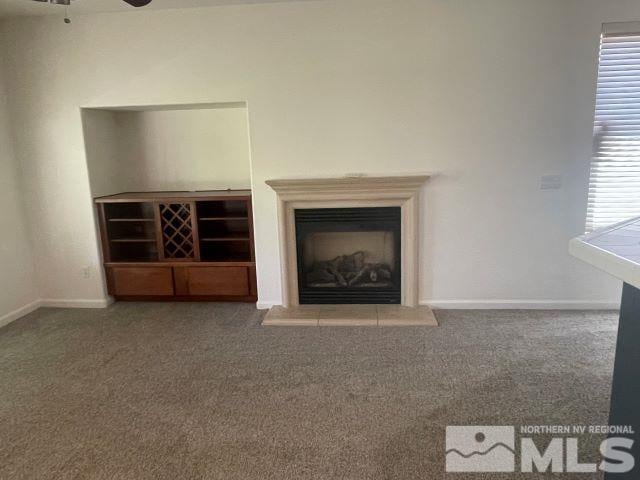 unfurnished living room featuring ceiling fan, plenty of natural light, and carpet floors