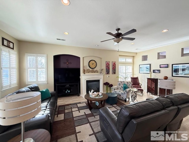 living room featuring ceiling fan and light wood-type flooring