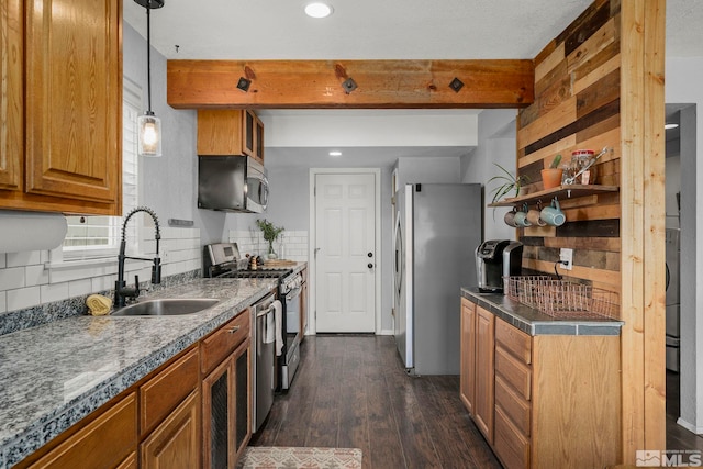 kitchen featuring dark hardwood / wood-style floors, beamed ceiling, sink, backsplash, and stainless steel appliances