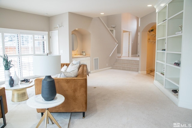 sitting room featuring light carpet