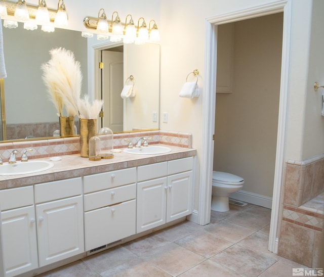 bathroom featuring vanity, tile patterned floors, and toilet