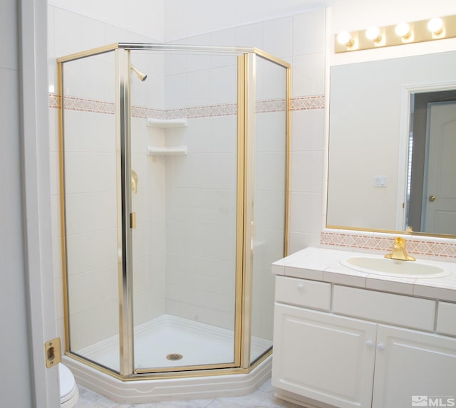 bathroom featuring vanity, an enclosed shower, backsplash, and toilet