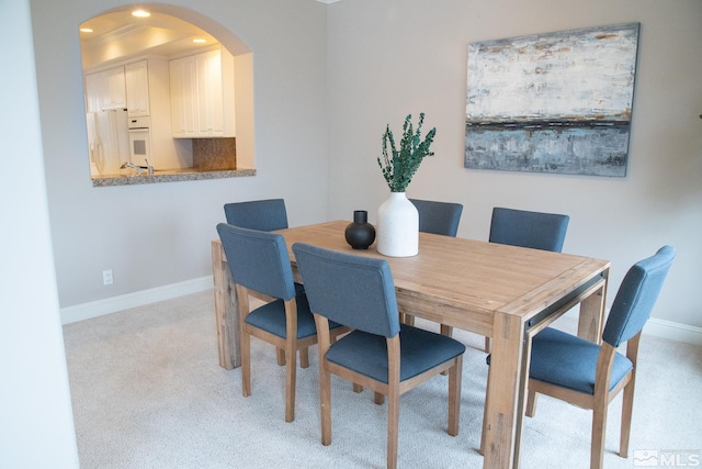 dining space with light carpet