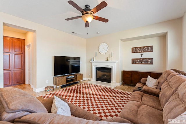 tiled living room featuring ceiling fan