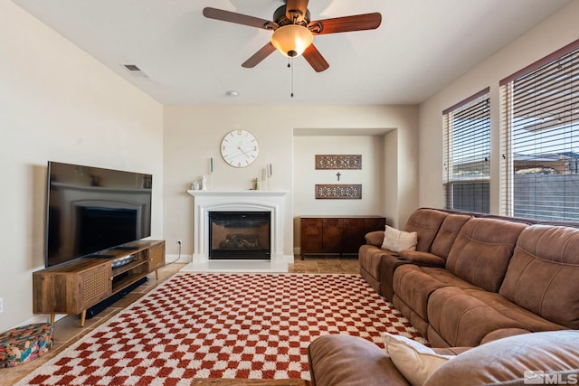 living room with ceiling fan and light tile patterned flooring