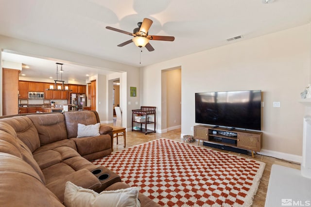 tiled living room featuring ceiling fan