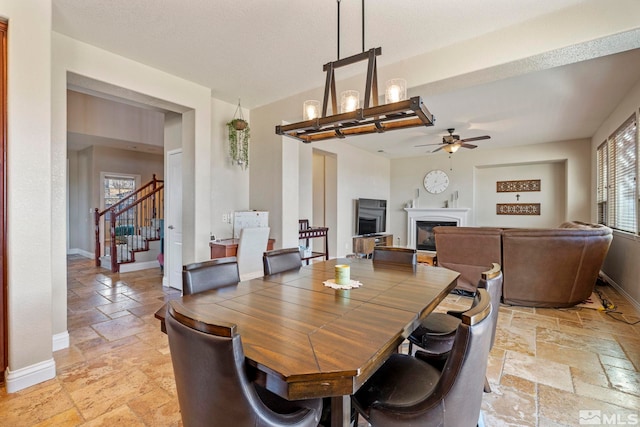 dining room with ceiling fan with notable chandelier