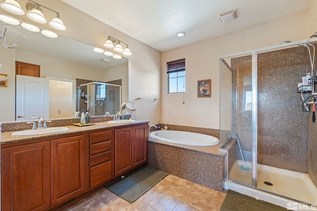 bathroom with vanity and separate shower and tub