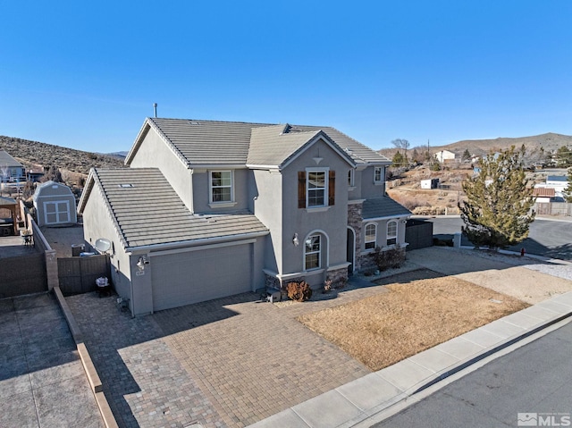 view of front property featuring a garage and a mountain view