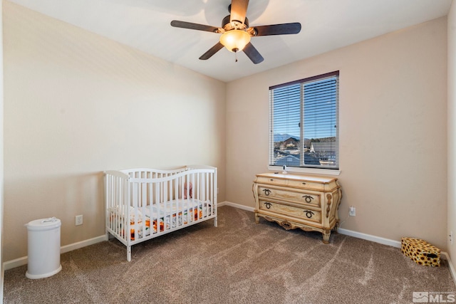 bedroom with a nursery area, ceiling fan, and carpet