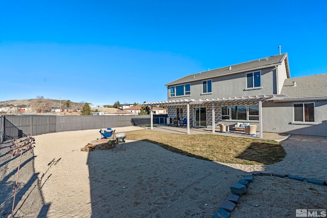 rear view of property with a patio and a pergola