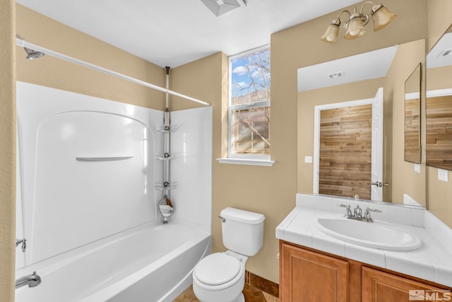 full bathroom featuring vanity, toilet, and washtub / shower combination