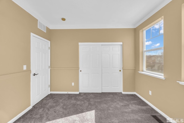 unfurnished bedroom with a closet and carpet flooring