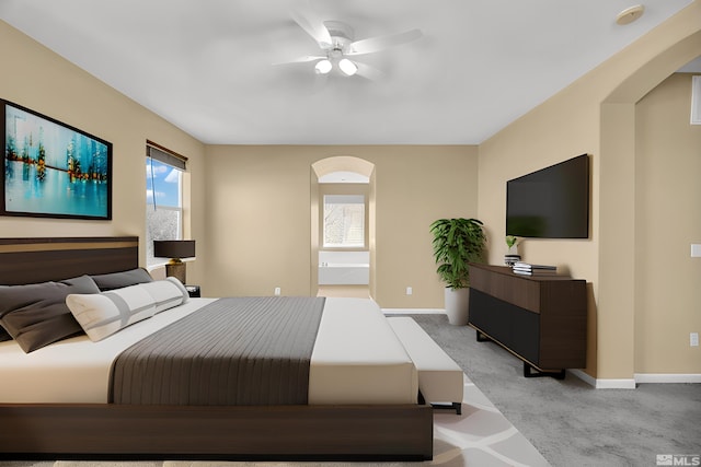 bedroom with light carpet, multiple windows, and ceiling fan