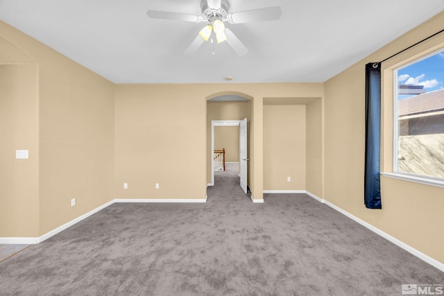 spare room featuring carpet and ceiling fan