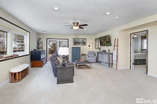 carpeted living room featuring ceiling fan