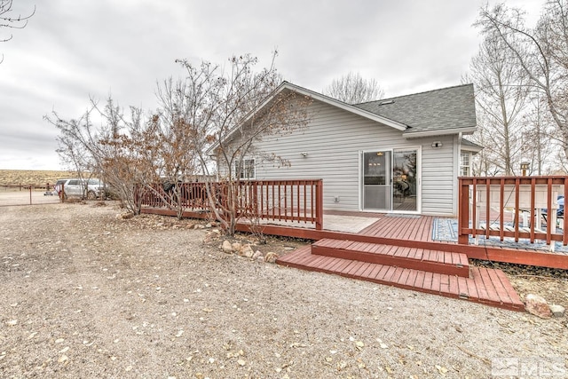 back of property featuring a deck