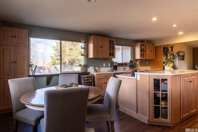 kitchen featuring stainless steel fridge, dark hardwood / wood-style floors, a kitchen island, beverage cooler, and light brown cabinets