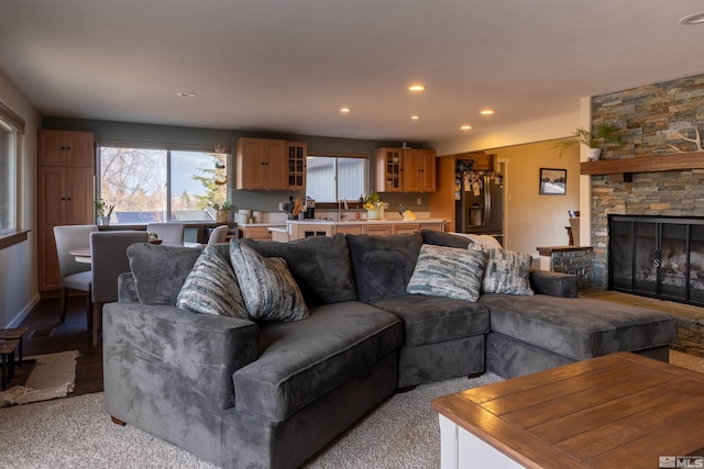 living room featuring sink and a fireplace