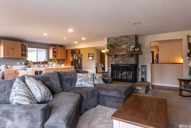 living room featuring a stone fireplace