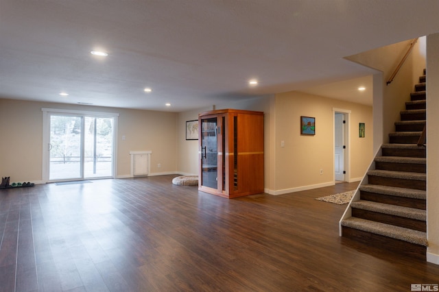 unfurnished living room with dark wood-type flooring