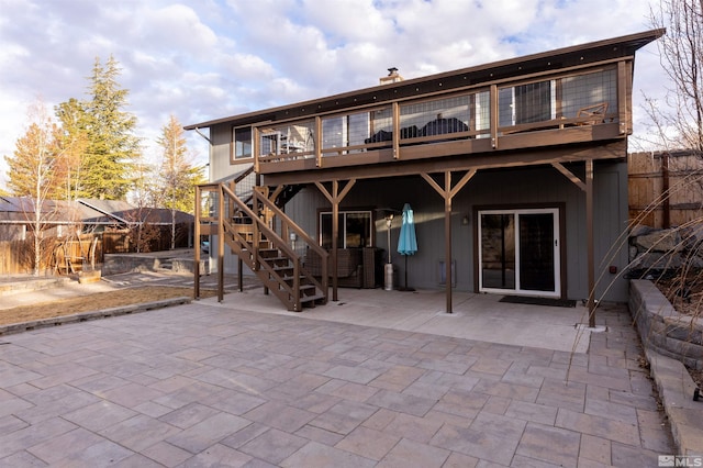 rear view of house with a deck and a patio area